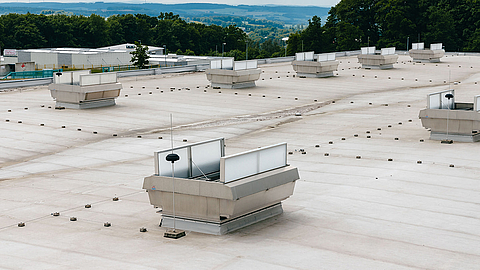 Roof of an industrial building with multiple ventilation systems